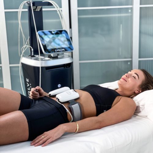Evolve treatment on a woman's abdomen